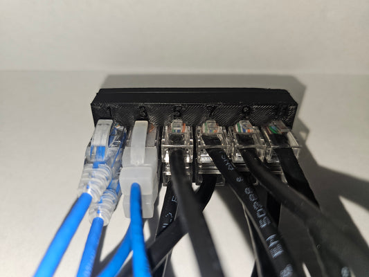 Network with multiple Ethernet cables plugged in on a white background